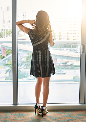 Buy stock photo Shot of a young businesswoman using her cellphone in the hotel room