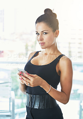 Buy stock photo Cropped portrait of a young woman using her cellphone in a hotel room