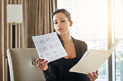 Buy stock photo Shot of a young businesswoman working in her hotel room