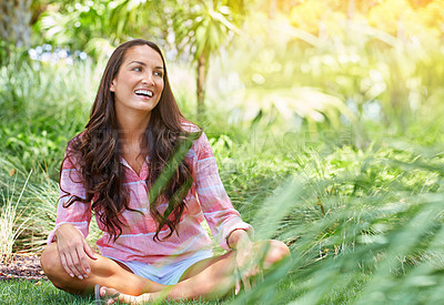 Buy stock photo Shot of an attractive young woman chilling in her garden