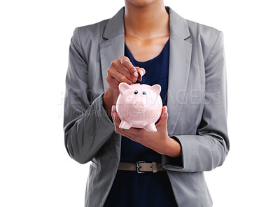 Buy stock photo Cropped shot of a businesswoman putting a coin into her piggybank