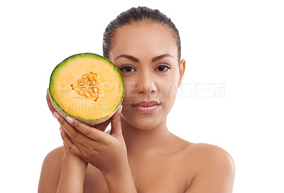Buy stock photo Studio shot of a young woman holding half a melon against a white background
