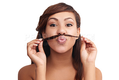 Buy stock photo Studio portrait of a young woman using her hair to make a moustache
