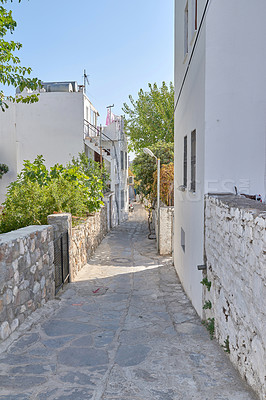 Buy stock photo Road, stone or path by houses for architecture, buildings or travel or exploration in Turkey. Bodrum, city or cobblestone in day for heritage, history or village design in Europe for aesthetic