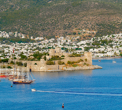 Buy stock photo City, urban and castle with ocean, boat or landscape of sea for holiday location or outdoor vacation. Water, beach or destination in Turkey for travel, ancient architecture or scenic view for tourism