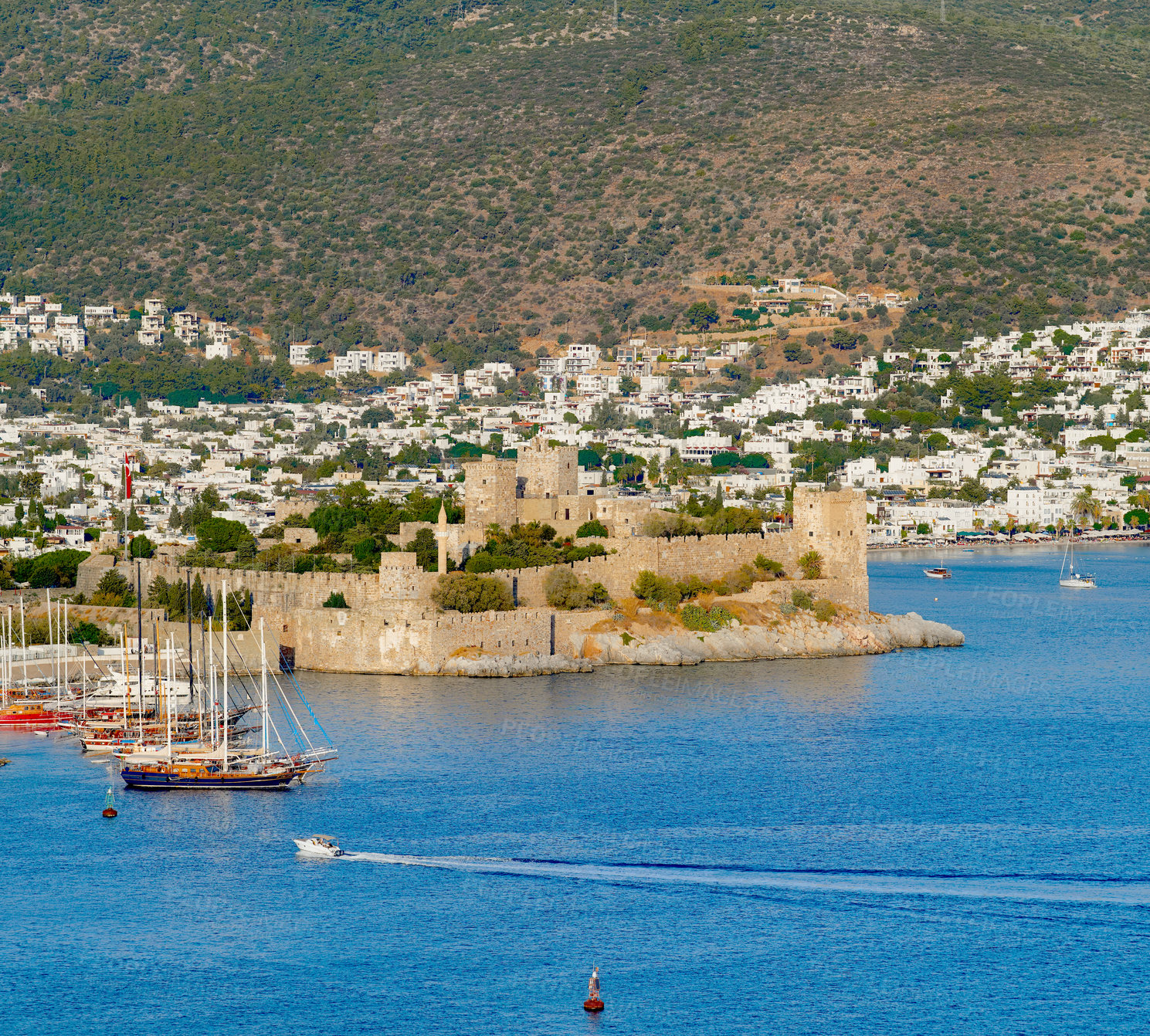 Buy stock photo City, urban and castle with ocean, boat or landscape of sea for holiday location or outdoor vacation. Water, beach or destination in Turkey for travel, ancient architecture or scenic view for tourism