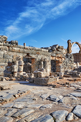 Buy stock photo Ancient city ruins of Ephesus in Turkey in the day. Traveling abroad and overseas for holiday, vacation and tourism. Excavated remains of historical stone building from Turkish history and culture