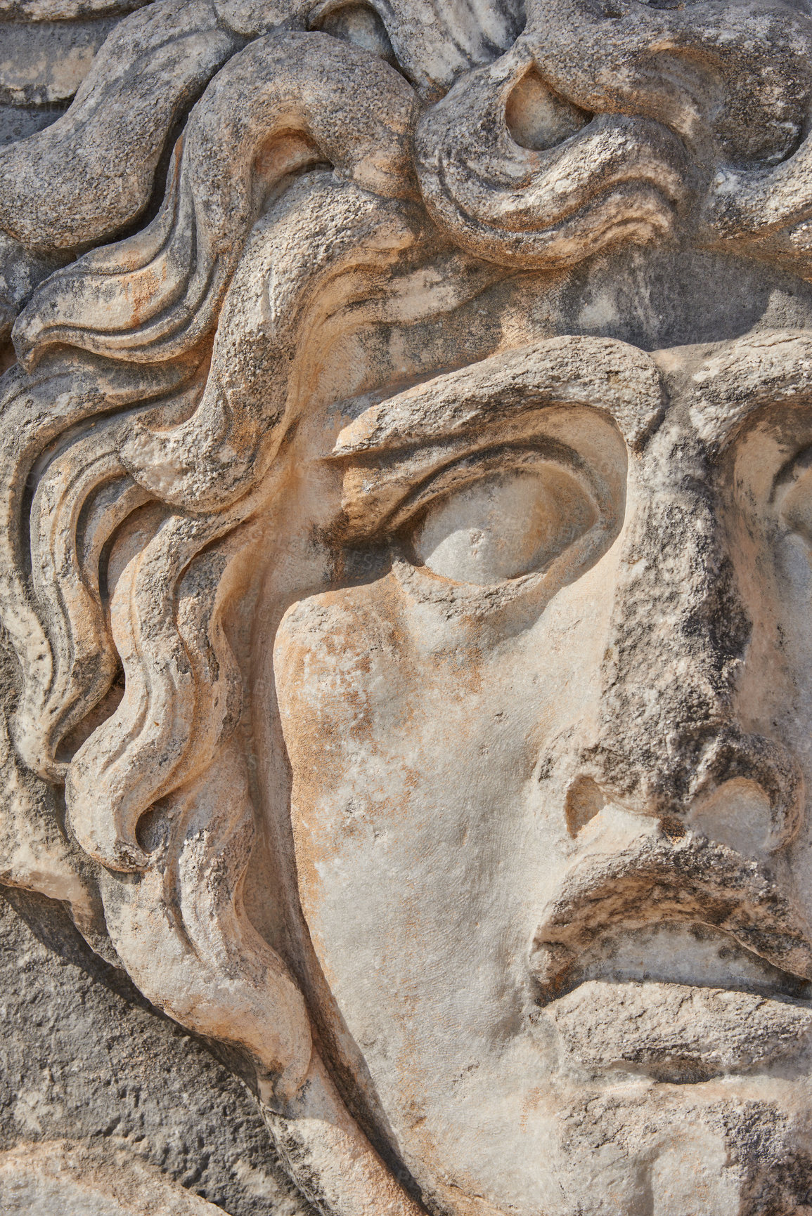 Buy stock photo Closeup of ancient stone sculpture of Medusa at the ruins of the Temple of Apollo at Didyma. Stone pattern detail of a face and architecture design in sacred site, Greek mythology history and culture