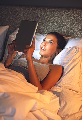 Buy stock photo Night, tablet and ebook for woman with smile in bed, relax and rest on soft mattress in bedroom. Digital, technology and reading for entertainment of female person, girl and adult in apartment