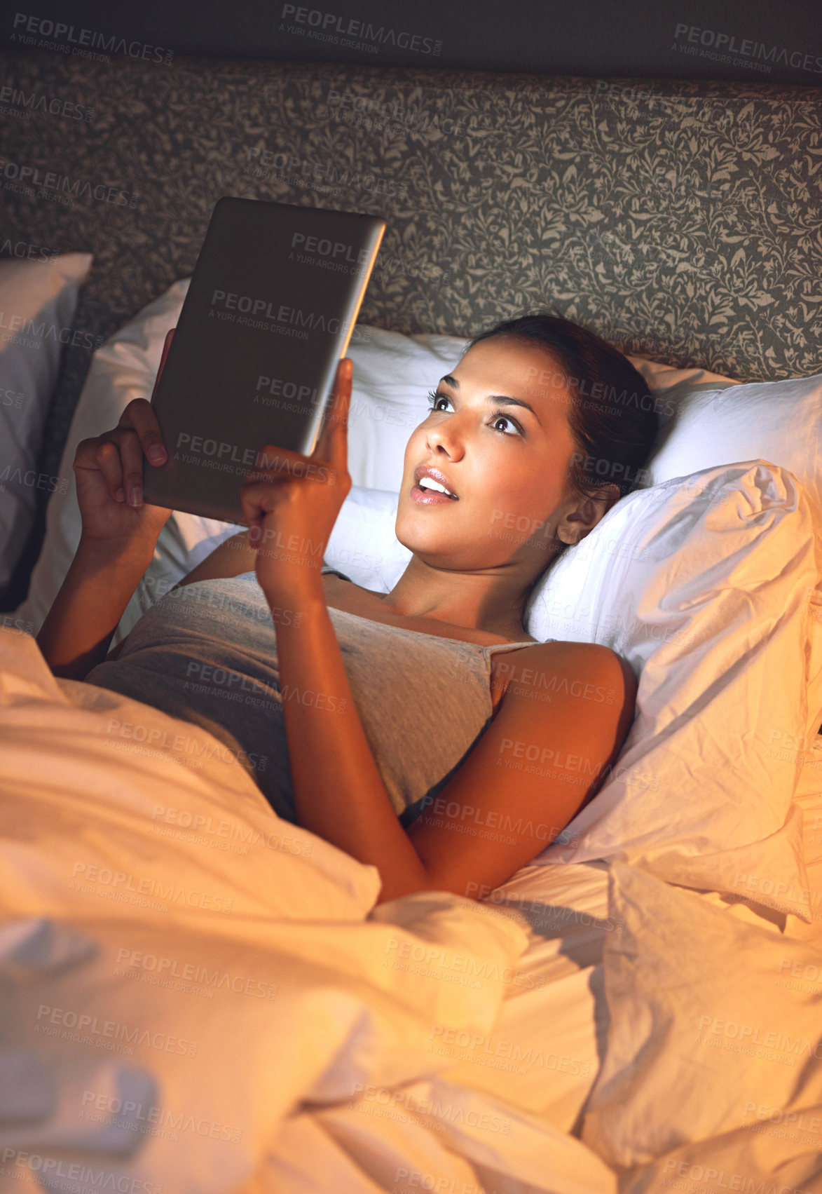Buy stock photo Night, tablet and ebook for woman with smile in bed, relax and rest on soft mattress in bedroom. Digital, technology and reading for entertainment of female person, girl and adult in apartment