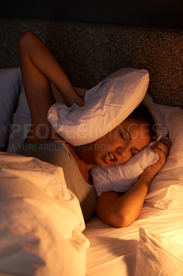 Buy stock photo Woman, bedroom and pillow at night with insomnia for annoyed noise in apartment for stress, nightmare or frustrated. Female person, bedding and light on mattress with headache, problem or anxiety