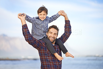 Buy stock photo Beach, portrait and happy man with child on shoulders, smile and mockup space on outdoor adventure. Support, face of father and son in nature for fun, bonding and trust on ocean holiday together