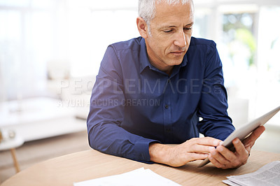 Buy stock photo Paper, remote work and senior man with tablet in home office for research, planning or communication. Financial, documents and elderly freelance male accountant with digital, app for investment check