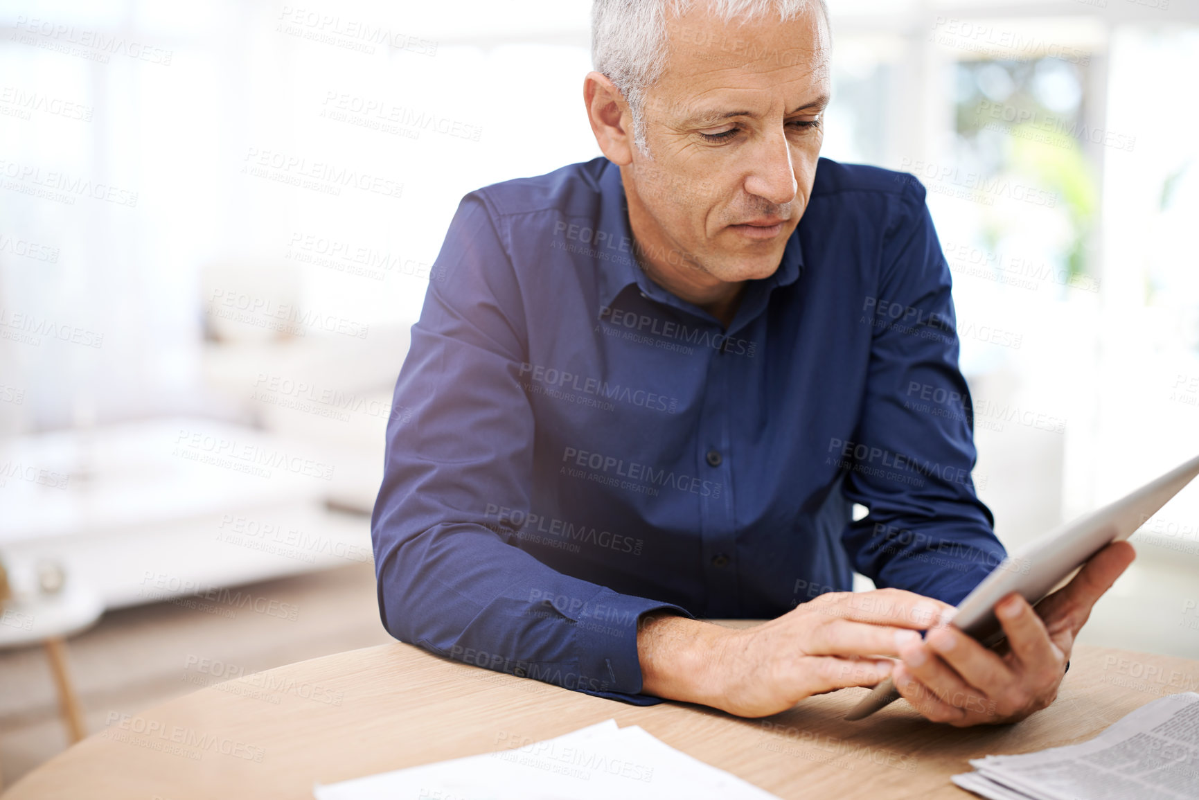 Buy stock photo Paper, remote work and senior man with tablet in home office for research, planning or communication. Financial, documents and elderly freelance male accountant with digital, app for investment check