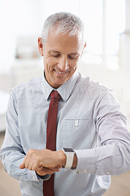 Buy stock photo Smile, happy and senior businessman with smartwatch in office for message, notification or text check. Tech, reading and elderly executive with digital watch, schedule or effective time management