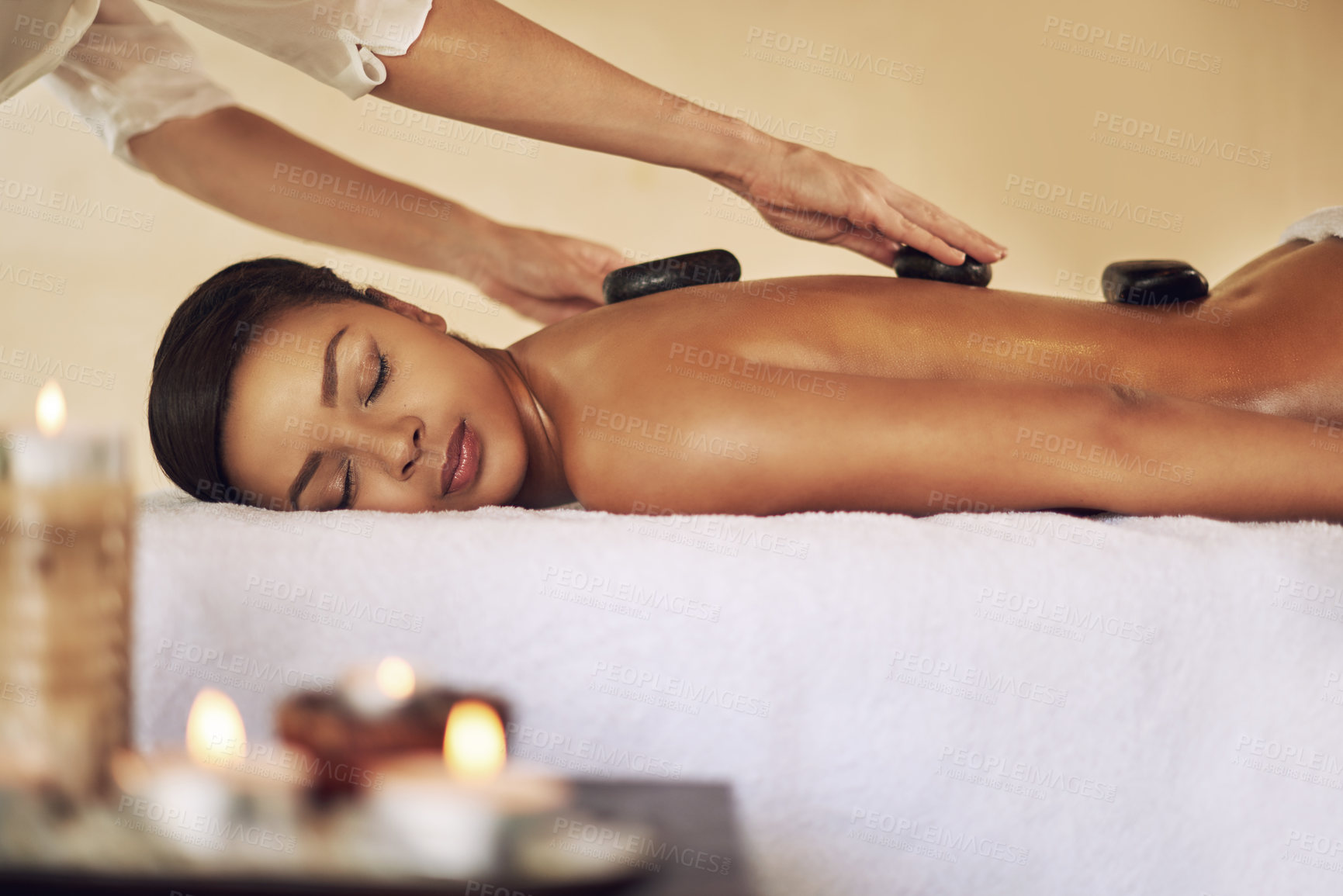 Buy stock photo Back massage, hot stone and relax with woman in spa for health, skincare or stress relief on bed. Beauty, peace and wellness with customer person at luxury resort for natural treatment or recovery