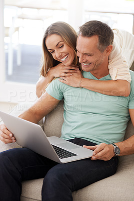 Buy stock photo Computer, hug and happy couple on sofa for internet, online reading and website review, together planning for home or marriage. Affection, love and relaxing mature partner, woman or people on laptop