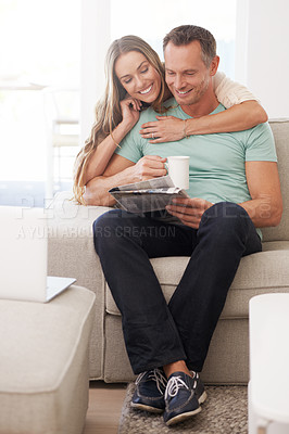 Buy stock photo Happy couple, love and newspaper with tea in house and bonding together with care in marriage. Man, woman and embrace by cappuccino for reading headlines, sofa and romantic indoor to relax on weekend