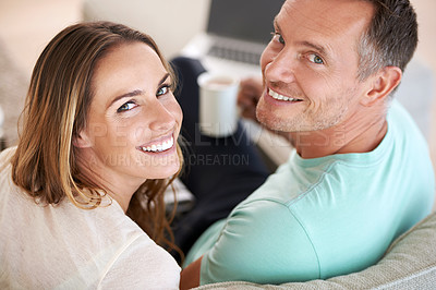 Buy stock photo Happy couple, smile and portrait with love in home, romantic and commitment with care in marriage. Man, woman and excited face for bonding in apartment, weekend and coffee on couch for online movies