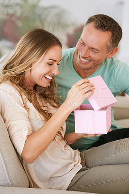Buy stock photo Woman open gift, man and happiness with surprise for birthday or anniversary, love and support with romance. Couple in marriage, unboxing package with ribbon and present for token of appreciation