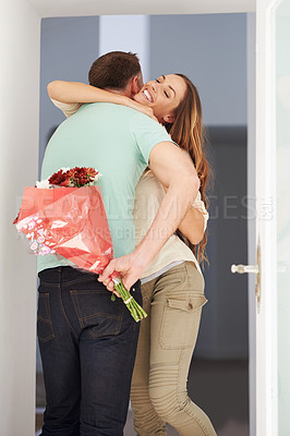 Buy stock photo Man, surprise or flowers for woman by front door, hug or happy couple to celebrate love in home. Husband, care or grateful with floral present for wife, gratitude for bonding together on anniversary