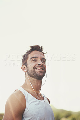 Buy stock photo Man, earphones and smile on road for running, music and motivation for cardio or training for marathon. Person, streaming and fitness on mountain for performance, athlete and playlist for exercise
