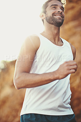 Buy stock photo Shot of a young man out for a run