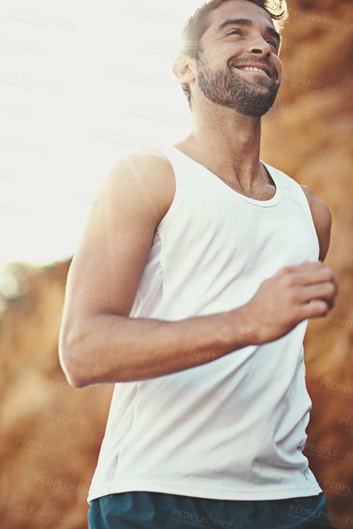 Buy stock photo Running, fitness and man in street for exercise, training and warm up for cardio workout. Health, sports and person with smile for wellness, nature and active for performance, challenge and marathon