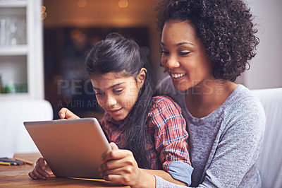 Buy stock photo Family, children or tablet with a mother and daughter busy with homework for education in the home together. Love, study or technology with a parent and female child bonding while learning in a house