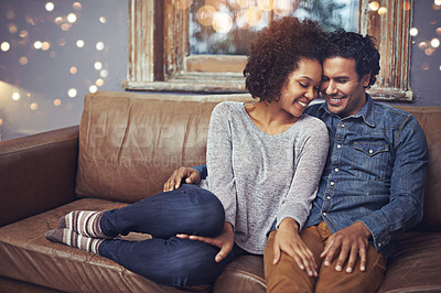 Buy stock photo Hug, love and happy couple relax on a sofa, romantic and bonding on date night with bokeh. Interracial relationship, romance and man embrace woman on a couch, smile and chilling in a living room