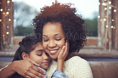 Buy stock photo Mother, child and hug on couch in home for weekend relaxing or holiday bonding, love or support. Woman, daughter and embrace connection in apartment living room for vacation care, youth or parenting