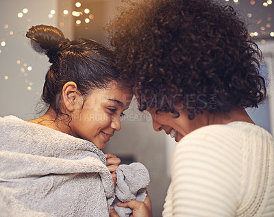 Buy stock photo Shot of a mother drying off her daughter with a towel in the bathroom