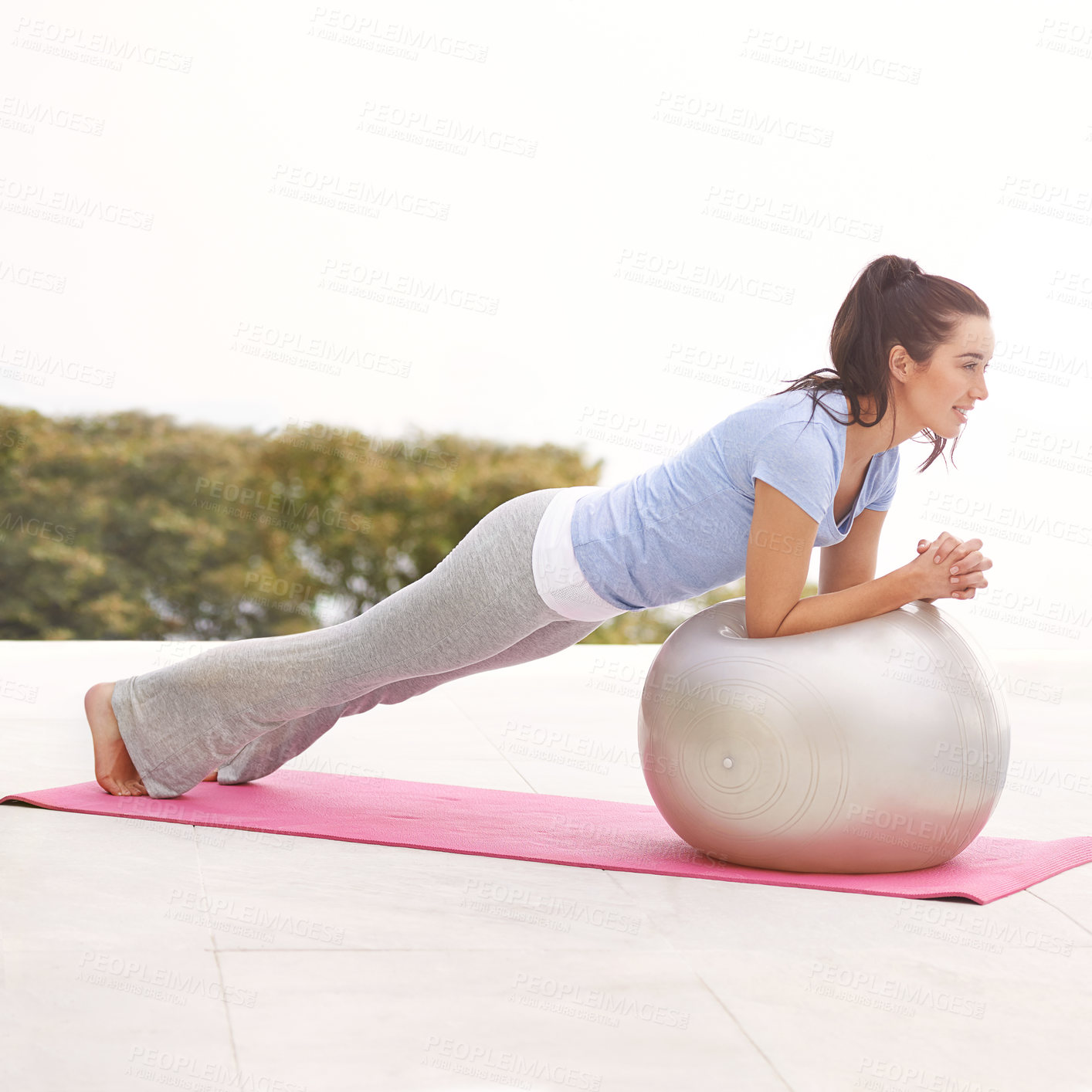 Buy stock photo Full length shot of a young woman doing yoga outdoors