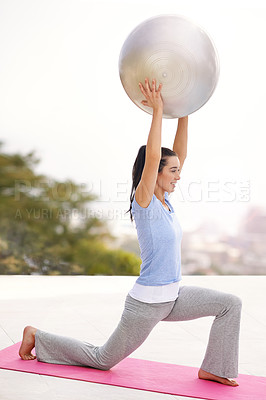 Buy stock photo Full length shot of a young woman doing yoga outdoors