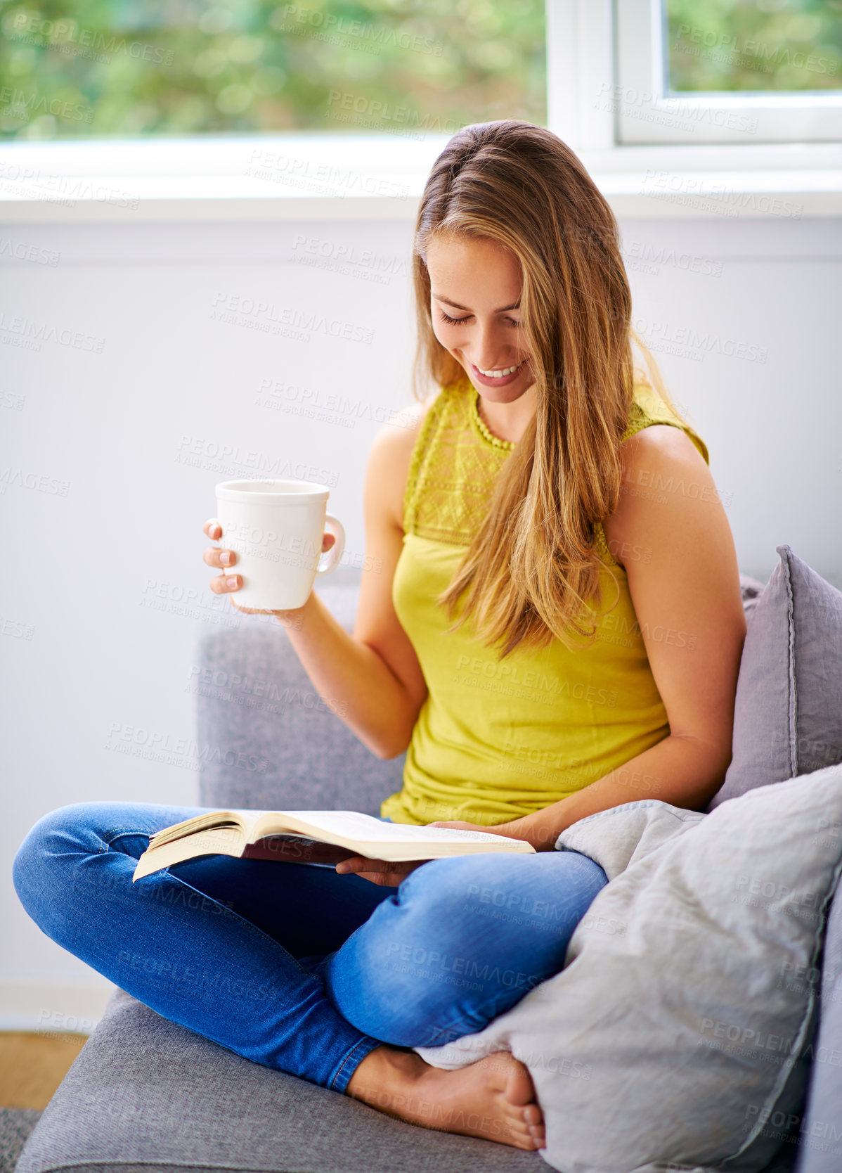 Buy stock photo Coffee, reading and happy woman on sofa with books in home for learning, knowledge and literacy. Literature, apartment and person with novel, story and fiction for hobby, peace or calm in living room