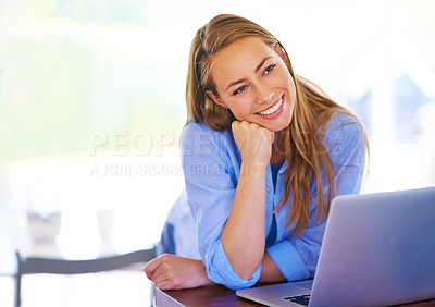 Buy stock photo Shot of a young woman sitting with her laptop at home