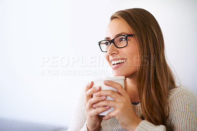 Buy stock photo Shot of a young woman having coffee at home