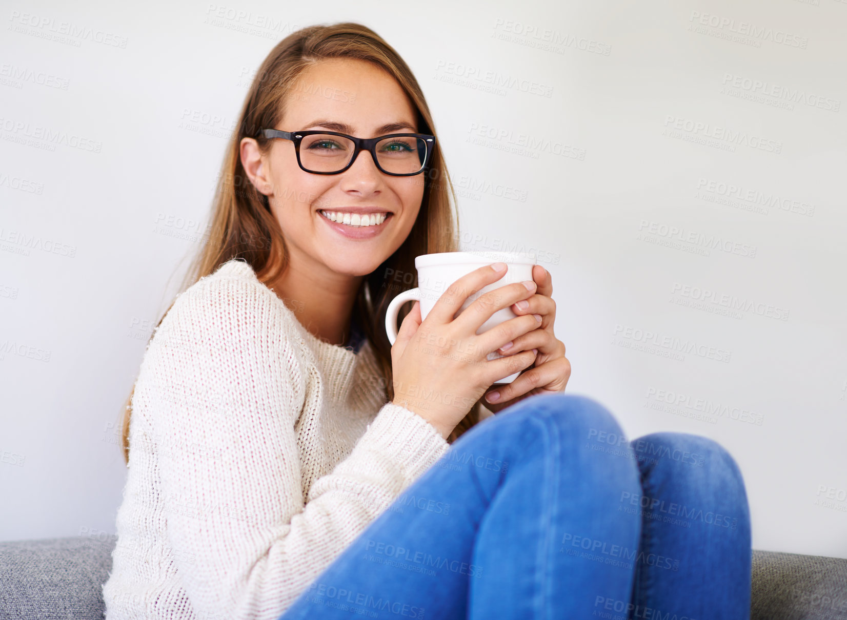 Buy stock photo Portrait, coffee and smile of woman in home enjoying caffeine, espresso or cappuccino in living room. Happiness, tea and female person with glasses on sofa, drinking beverage and relax in house alone