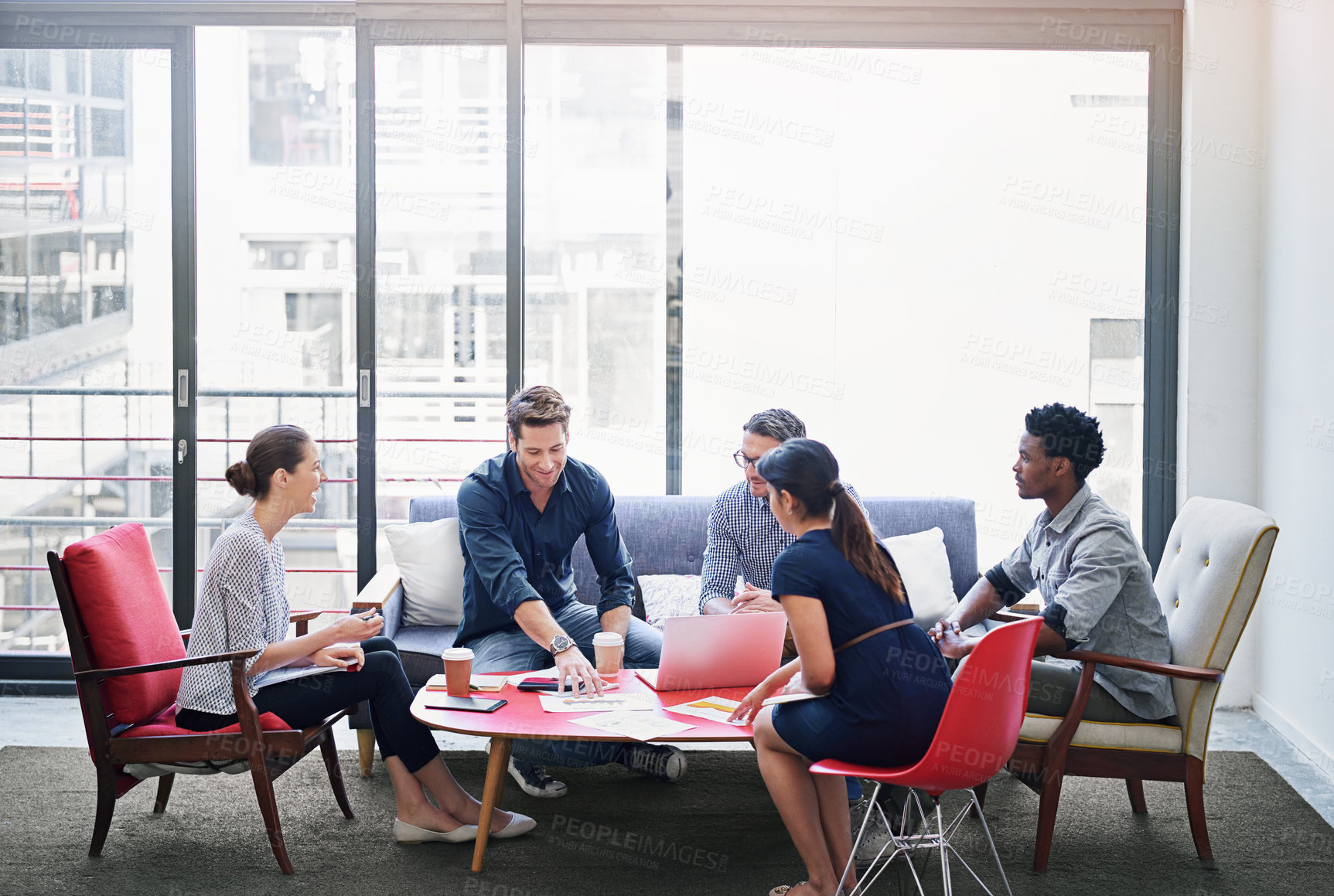 Buy stock photo Shot of a group of coworkers in a meeting in an office