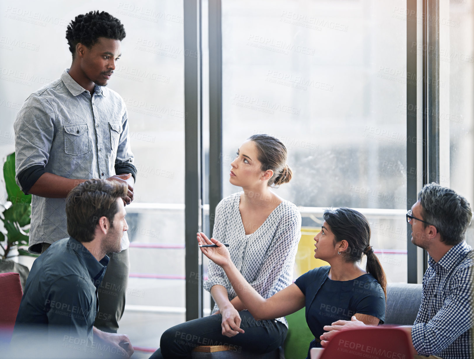 Buy stock photo Shot of a group of coworkers in a meeting in an office