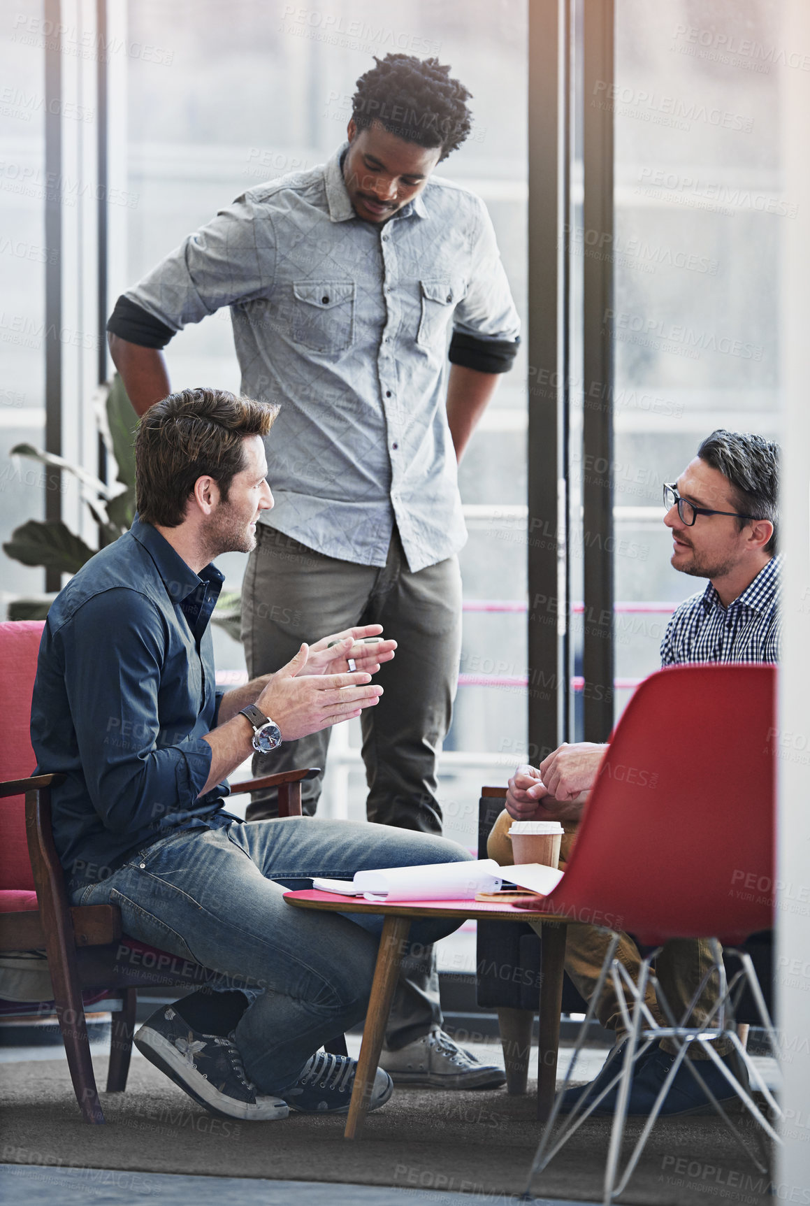 Buy stock photo Shot of a group of coworkers in a meeting in an office