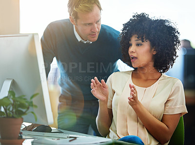 Buy stock photo Business people talking, training and discussing a creative strategy working on a desktop computer together in an office at work. Black female employee explaining an idea to a male manager on a pc
