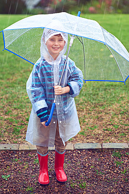 Buy stock photo Full length portrait of a young boy standing outside in the rain