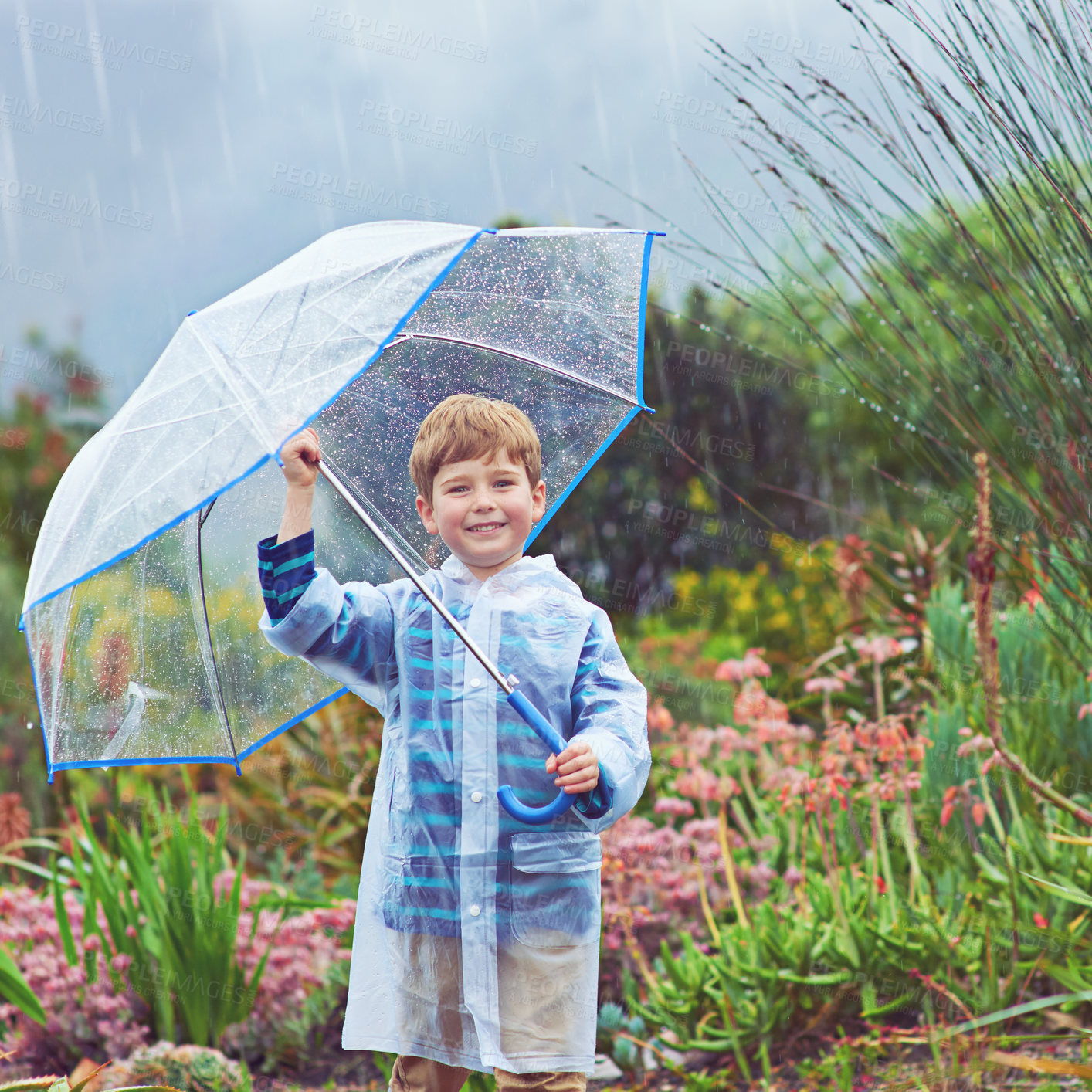 Buy stock photo Cropped portrait of a young boy standing outside in the rain