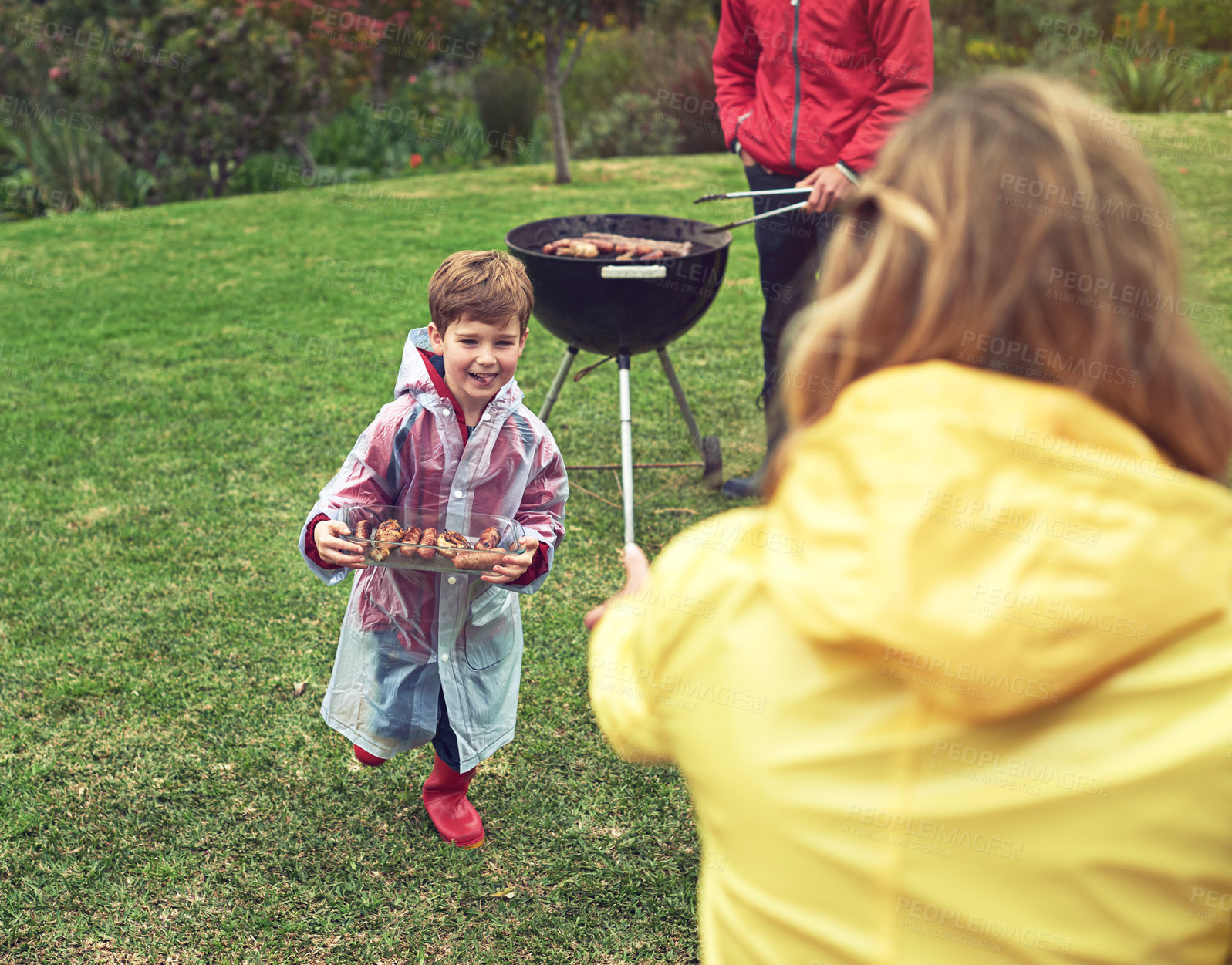 Buy stock photo Shot of a family enjoying a barbecue outside