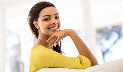 Buy stock photo Shot of an attractive young woman relaxing on the sofa at home