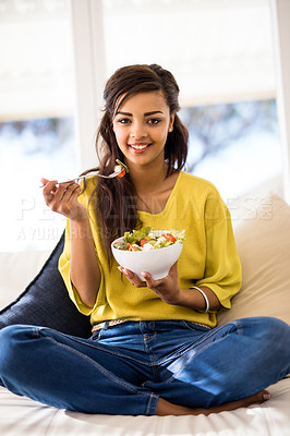 Buy stock photo Portrait of a young woman eating a salad at home