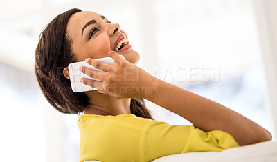 Buy stock photo Shot of a young woman talking on her cellphone at home