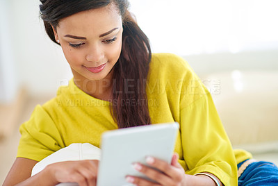 Buy stock photo Woman, tablet and house on couch for e learning, fun or online with chat, social media and streaming. Female person, home and relax for break, communication and internet for tech, typing or browsing