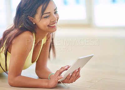 Buy stock photo Young, woman and tablet on floor with happy for connectivity, streaming or online shopping. Female person, technology and smile for social media, e learning and gaming in chat or texting